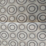 Square swatch upholstery fabric with circles (within circles) print in white/black/grey shades