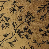Square swatch wideback material in light brown/bronze shade with black branch like greenery pattern