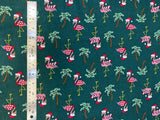 Flat swatch winter themed flannel in Christmas flamingo (sweater/scarf and santa hat wearing flamingos with decorated palm trees on dark green)