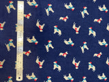 Flat swatch winter themed flannel in Winter dogs (white dogs with red and blue scarves and hats on dark blue)