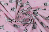 Swirled swatch little zebra fabric (baby pink fabric with tossed small blue and medium pink polka dots, cartoon smiling zebra repeated allover)