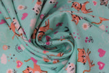 Swirled swatch pretty kitty fabric (light teal fabric with tossed cartoon white, grey, and orange kittens and tossed pink, orange and white hearts, floral, clouds, butterflies)