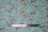 Flat swatch pretty kitty fabric (light teal fabric with tossed cartoon white, grey, and orange kittens and tossed pink, orange and white hearts, floral, clouds, butterflies)