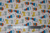 Flat swatch kitty love fabric (white fabric with cartoon tossed kittens in grey, yellow with orange polka dots, blue with orange sweaters, and orange with blue sweaters, tossed red heart outlines)