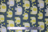 Flat swatch yellow elephants fabric (dark pale blue fabric with white and yellow cartoon rounded look elephants in various sizes trunks faced to each other with tossed yellow hearts)