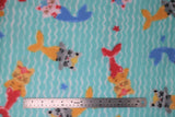Flat swatch mermaid cats fabric (light blue fabric with white wave look lines allover and tossed cartoon cats with mermaid tales in grey, orange, pink, blue, red and tossed stars)