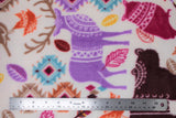 Flat swatch patterned forest animals fabric (white fabric with colourful deer, bears, owls, birds, with lines of tribal/mandala style pattern within. Tossed leaves and small patterned patches. All in a purple, brown, burgundy, orange, yellow, pink, red, blue colourway)