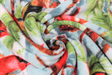 Swirled swatch spruce cardinal fabric (light blue/white sky look fabric with green and brown spruce tree branches holding red cardinals, red berries, and pinecones)
