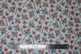 Flat swatch Apple Blossom fabric (white fabric with tossed drawn style floral heads in pale red and pink with green and blue leaves and tossed "Apple Blossom" cursive writing in black)