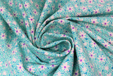 Swirled swatch Aqua Dasies fabric (small aqua blue floral tossed allover with medium sized white floral heads with purple centers)