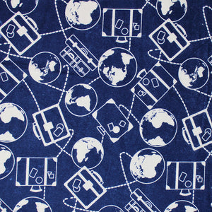 Square swatch Around the World fabric (dark blue fabric with white suitcase outlines and planet earth's with dotted directional lines connecting all in busy collage style)