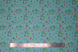Flat swatch flowers fabric (teal fabric with tossed tiny cartoon floral clusters with stems in green, teal, red, pink, yellow)