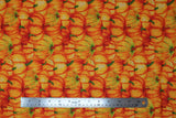 Flat swatch Stacked Pumpkins fabric (busy collaged orange illustrative style pumpkins allover with subtle gold sparkle effect)