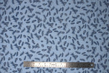 Flat swatch winter printed fabric in Pinecones on Light Blue
