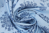 Swirled swatch winter printed fabric in Snowflakes on Light Blue