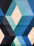 Blue, teal, grey and black bars and off-white diamonds form a cubic optical illusion on this printed upholstery