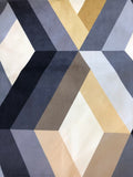 Gold, tan, grey and black bars and off-white diamonds form a cubic optical illusion on this printed upholstery