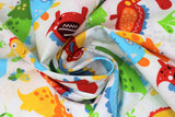 Swirled swatch Baby Dinos fabric (white fabric with tossed cartoon style baby dinosaurs in various styles and colours with tossed greenery, eggs and bones all in green, blue, yellow, orange and red shades)