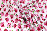 Swirled swatch garden themed printed fabric in Pink Flowers & Green Leaves on White