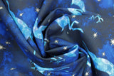 Swirled swatch Blue Reindeer fabric (dark blue marbled look fabric with tossed light blue marbled reindeer in various poses and tossed sparkly silver metallic effect stars)