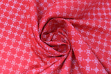 Swirled swatch Boots and Spurs printed fabric in White Diamonds & Flowers on Red