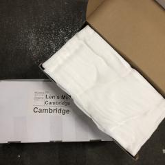 An open box of folded cheesecloth resting on a closed box marked "Len's Mill Cambridge, Cambridge"