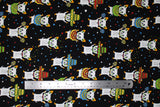 Flat swatch sombrero chihuahua fabric (black fabric with tossed white cartoon chihuahua dogs either holding maracas, wearing sombreros, or wearing ponchos all in a green, red, yellow, blue, orange colourway with tossed tiny circles, squares and triangles in same colours allover in background)