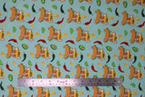 Flat swatch taco chihuahua fabric (teal fabric with tossed cartoon yellow and orange tortilla chips, green and red peppers/chilis, green lime wedges and green avocado halves with repeated pattern of tan chihuahua dogs with a hard shell taco for a body, wearing a sombrero)