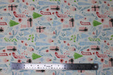 Flat swatch Sparkle Stockings fabric (white fabric with busy tossed christmas emblems allover in messy drawn style: stockings, gifts, trees, etc. in blue, pink and green colours with gold and silver metallic effect sparkles allover)