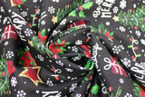 Swirled swatch Be Merry, Happy Holidays fabric (black fabric with loosely tossed christmas elements allover: white snowflakes, "Happy Holidays" "Be Merry" white text, red presents, red and gold stars, green christmas trees, green and red holly and poinsettia plants)