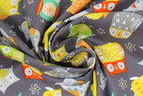 Swirled swatch Colourful Owls fabric (charcoal grey fabric with busy tossed colourful doodle style owls allover in grey, yellow, green, teal, red shades)