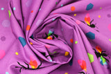 Swirled swatch colourful print in purple (bees and multi-coloured hexagons)