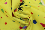 Swirled swatch colourful print in yellow (bees and multi-coloured hexagons)