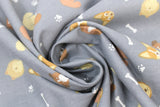 Swirled swatch dog bones fabric (medium grey fabric with tossed white dog bones and paw prints, and tossed cartoon dog heads in tan, white and brown shades and different breed/styles)