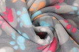 Swirled swatch colourful paws grey fabric (dark grey fabric with light grey large polka dots and white, blue, pink, magenta and orange large paw prints)