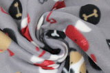 Swirled swatch dogs and bones fabric (medium grey fabric with cartoon dogs in tan, white, and burgundy combinations tossed with black bone outlines and black polka dots with white and burgundy bones)