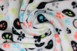 Swirled swatch colourful paws white fabric (white fabric with small tossed paw prints in lime green, pale coral, blue, grey, black some plain, some with black circle outlines and some with solid black polka dot backgrounds)