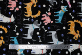 Flat swatch dogs fabric (black fabric with tossed illustrative style colourful dogs in various breeds allover with white bones, purple paw prints and white swirls)