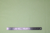 Flat swatch jubilee fabric (pale lime green fabric with white diamonds/mesh look and tiny green dots between)