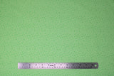 Flat swatch Keep on Truck'n fabric (bright green fabric with medium pale green water droplet look dots allover)