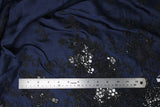 Flat swatch of blue and black embroidered satin