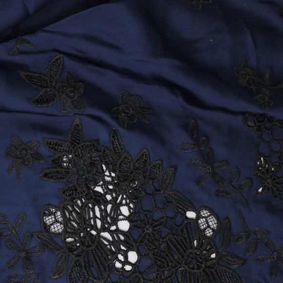 Swatch of blue and black embroidered satin