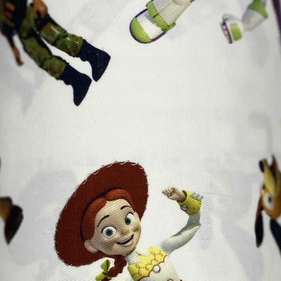 Square swatch Toy Story (Licensed) print cotton fabric. Cartoon characters tossed on white.
