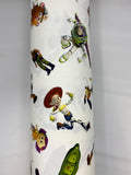 Roll of Toy Story (Licensed) print cotton fabric with cartoon characters tossed on white
