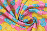 Swirled swatch multi colour flowers fabric (brightly coloured floral heads in yellow, pink, and baby blue collaged allover in various sizes)