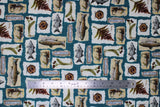 Flat swatch fly fishing fabric (blue green fabric with white sqaure and rectangular labels/badges allover with coloured fishing elements within: fish, fish drawing, "Fly Fishing" text, lures, etc.)