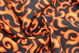 Swirled swatch Flames fabric (black fabric with tossed orange and yellow abstract flame look shapes allover)