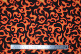 Flat swatch Flames fabric (black fabric with tossed orange and yellow abstract flame look shapes allover)