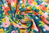 Swirled swatch corsage fabric (dark teal fabric with large tossed floral groupings in rough painted look in pink, dark pink, yellow, orange and green floral heads with white and line leaves and greenery)