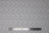 Flat swatch Ivory Woods fabric (ivory fabric with dark grey leaf outlines in small, medium and large sizes)